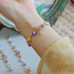 Bracelet artisanal en émail avec perles papillon et trèfle 